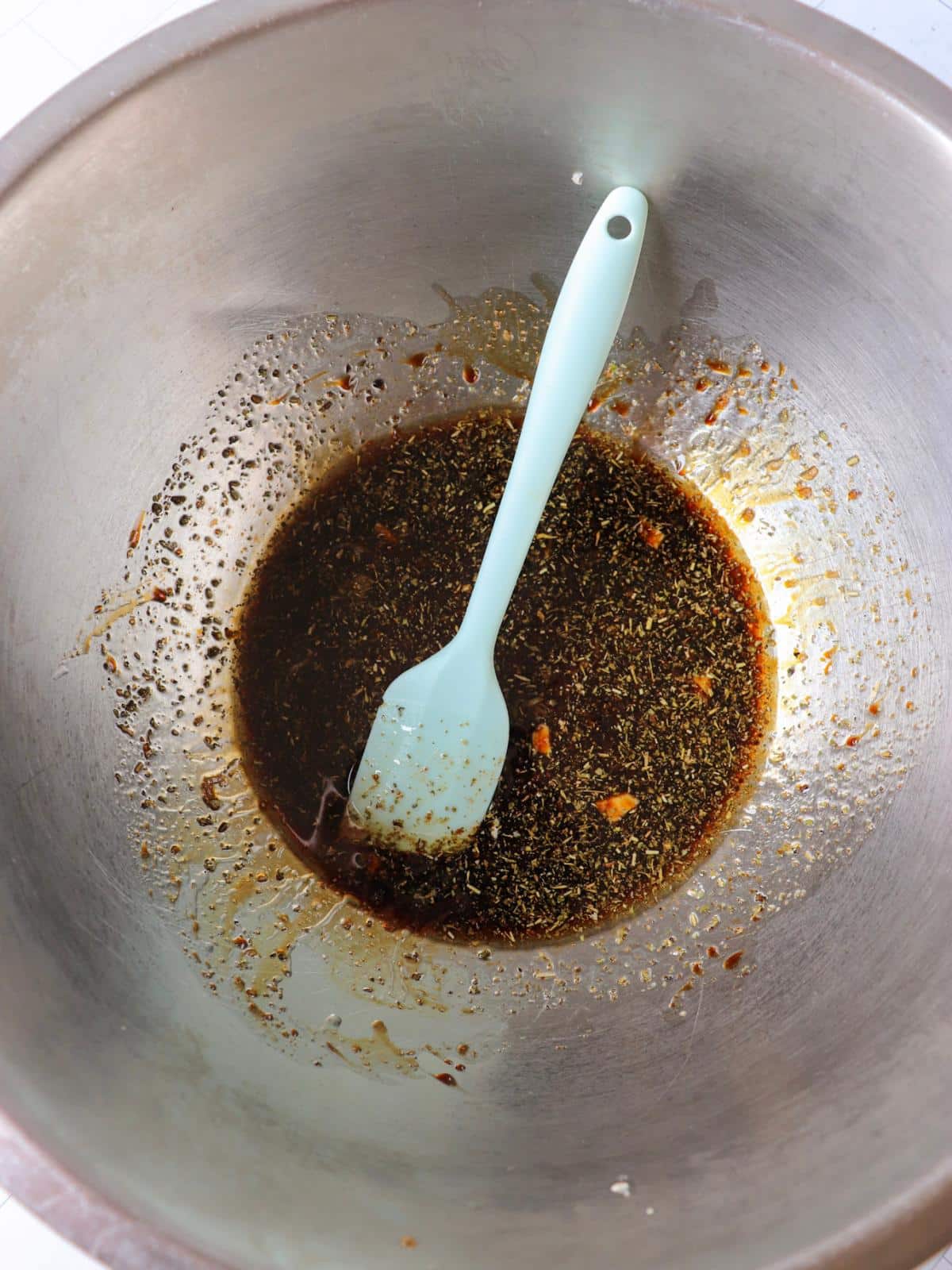 Homemade balsamic vinaigrette in a large mixing bowl.