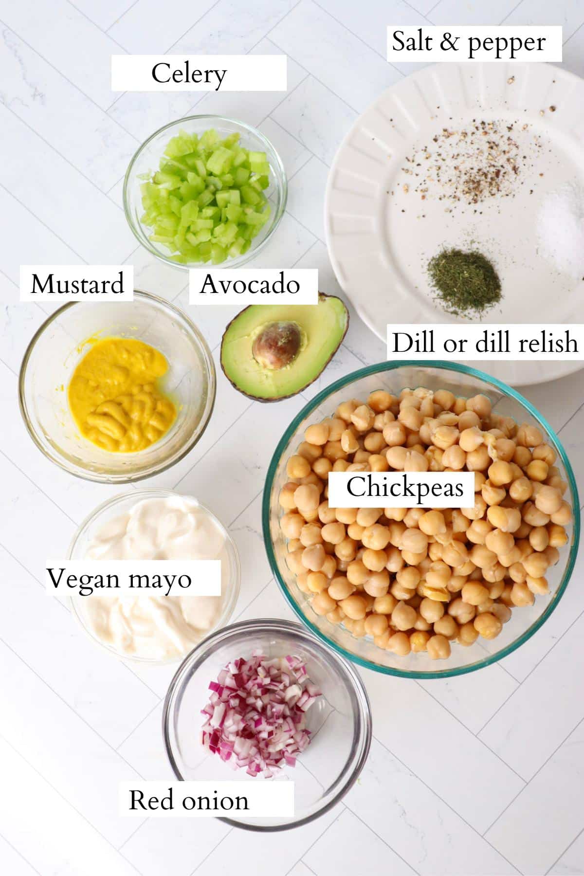 Chickpea salad sandwich ingredients laid out on a counter.
