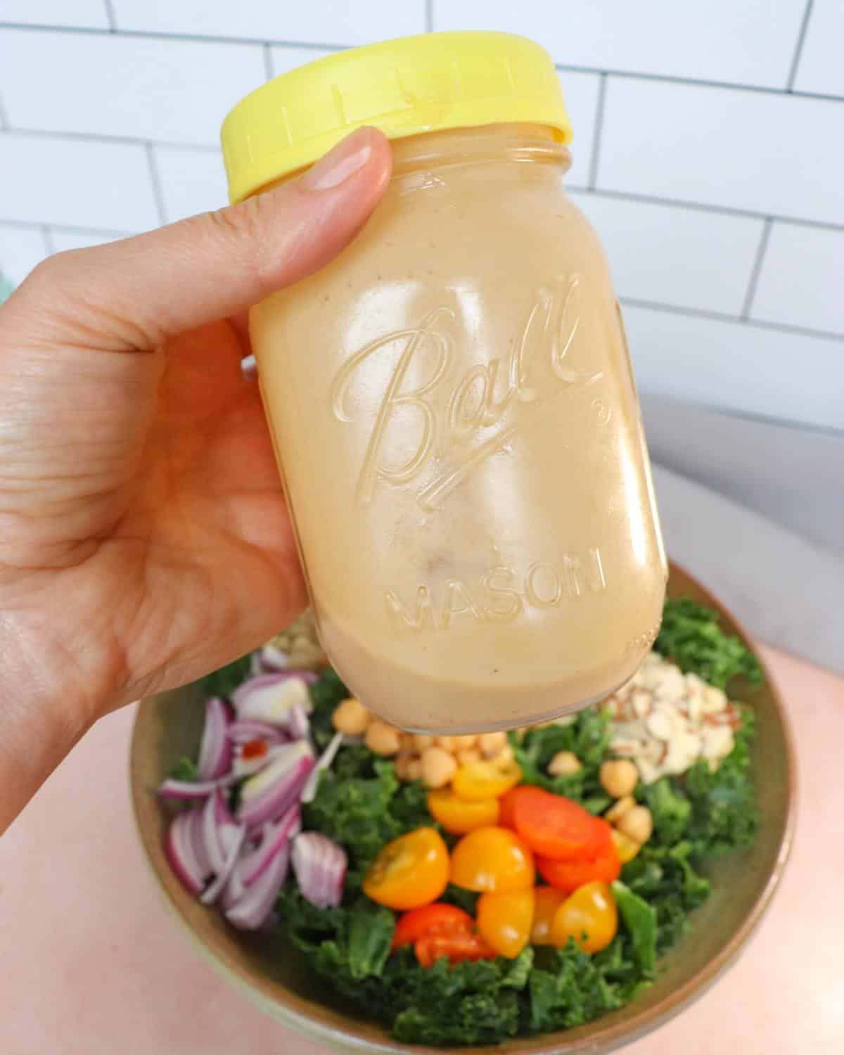 Tahini dressing in a small mason jar.