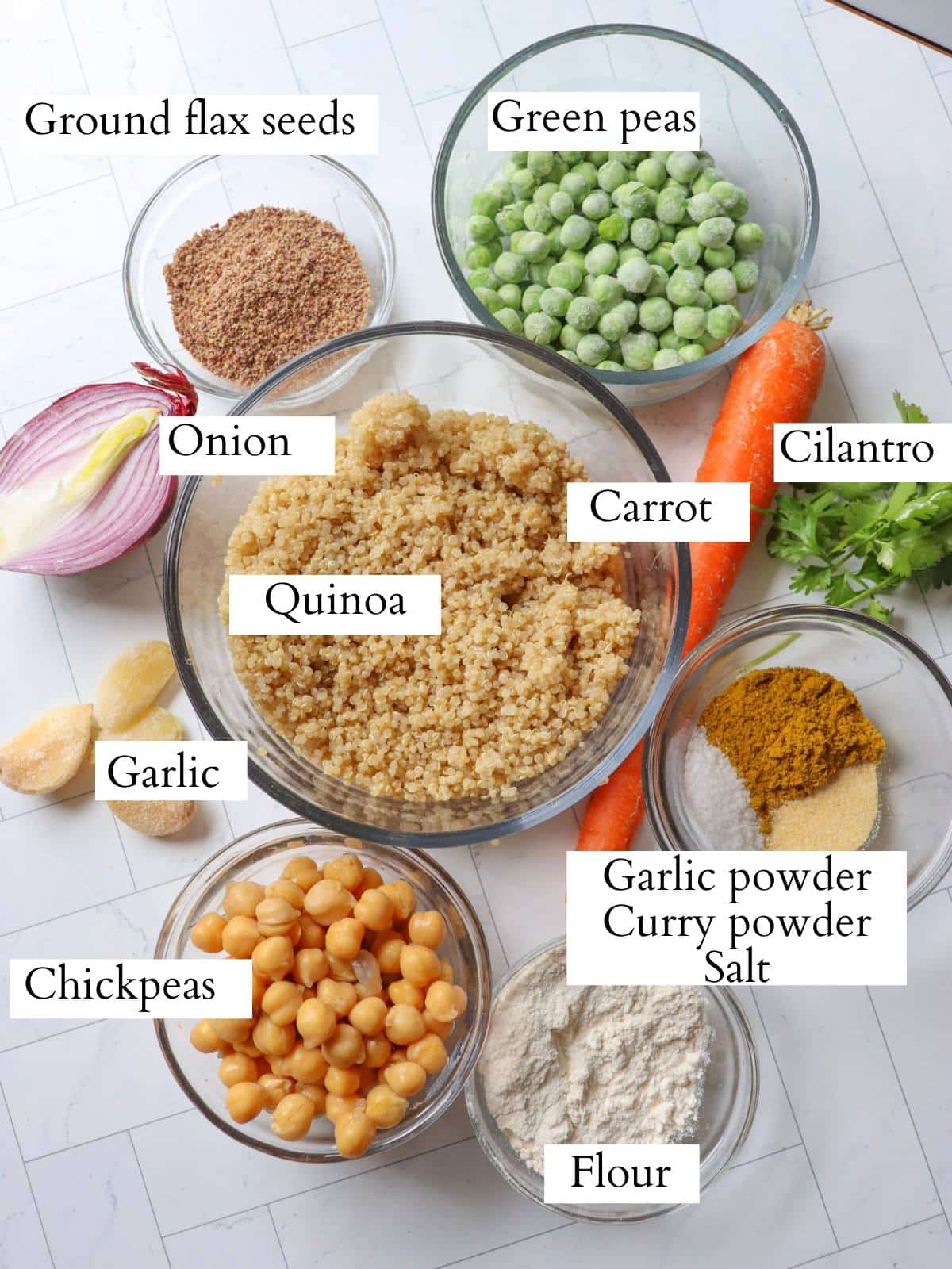 Ingredients for quinoa chickpea burgers laid out on a kitchen counter.