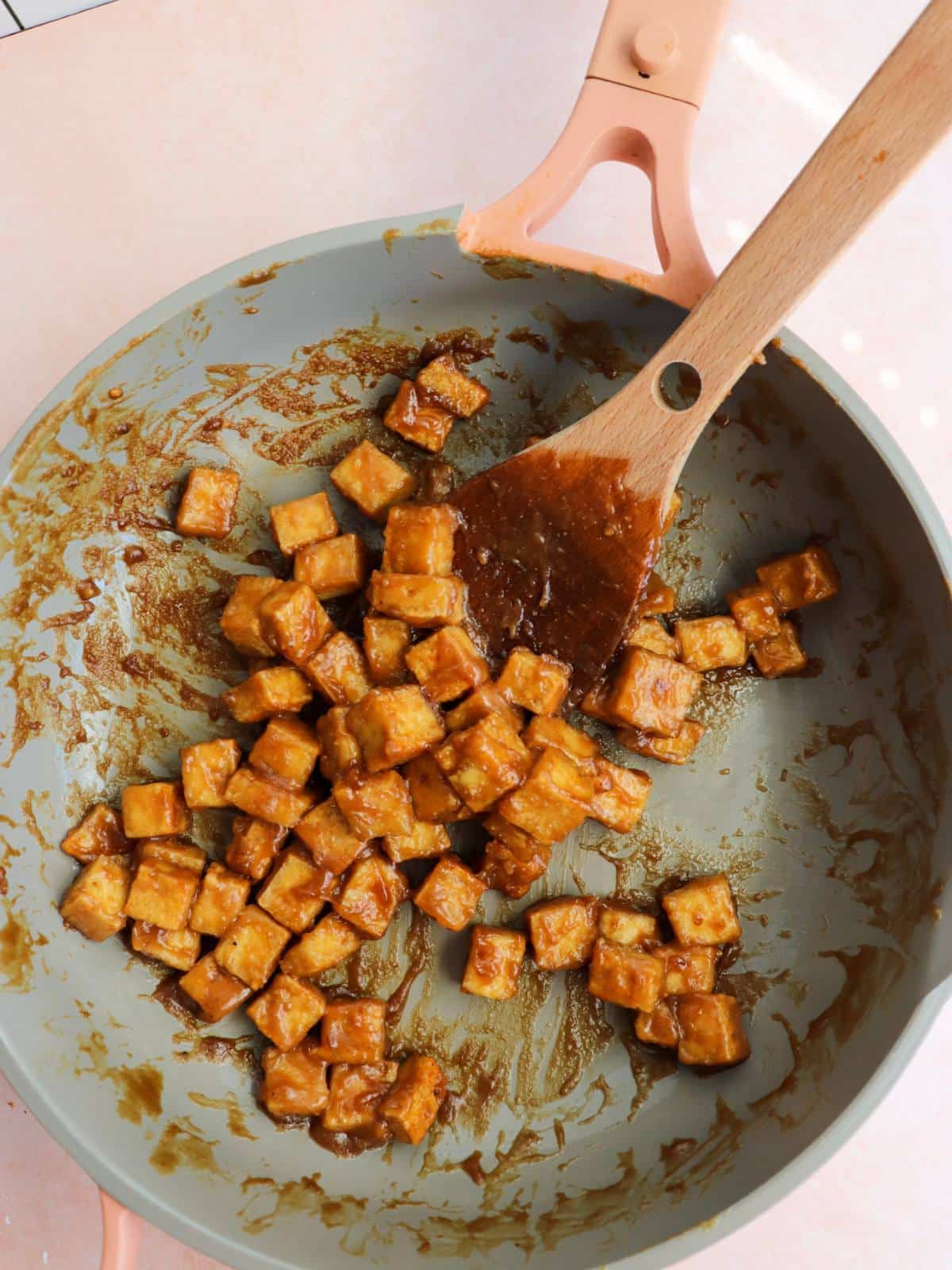 Sticky miso tofu marinade in a pan with tofu cubes.