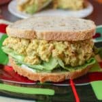 Chickpea salad sandwich with lettuce and vegan mayo on a plate.