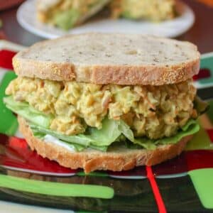 Chickpea salad sandwich with lettuce and vegan mayo on a plate.
