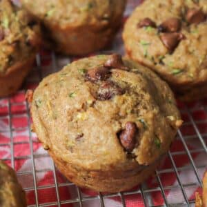 Vegan chocolate chip zucchini muffins cooling on a wire cooling rack.