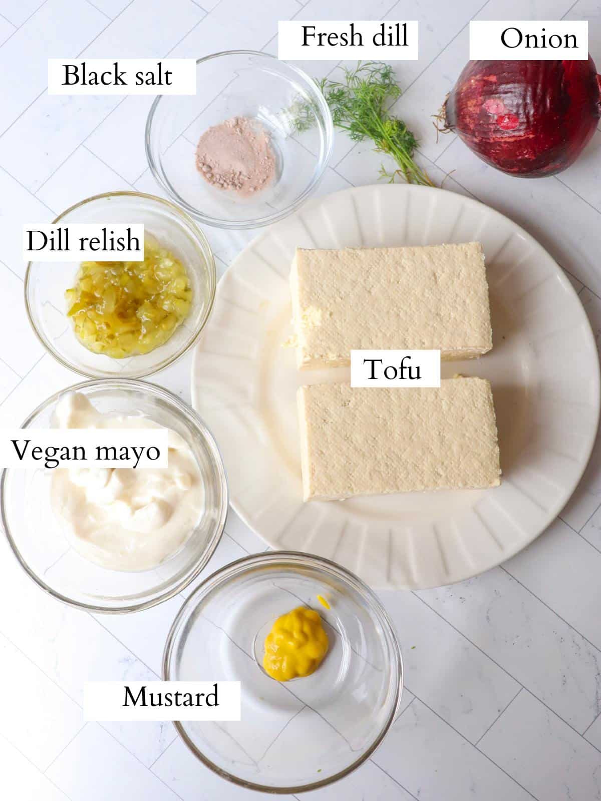 Ingredients for vegan tofu egg salad laid out on a kitchen counter.