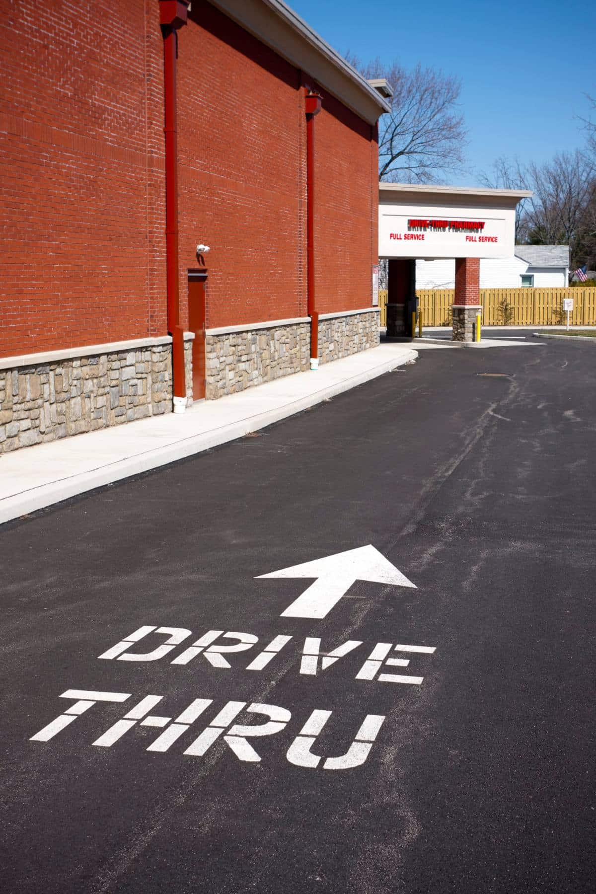 A fast food drive through lane with the words Drive thru painted on the ground. 