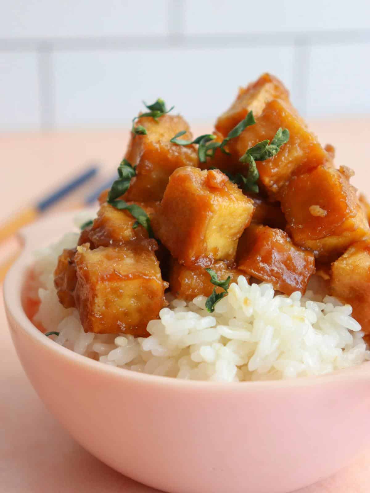 Sticky tofu with miso glaze in a bowl over rice.