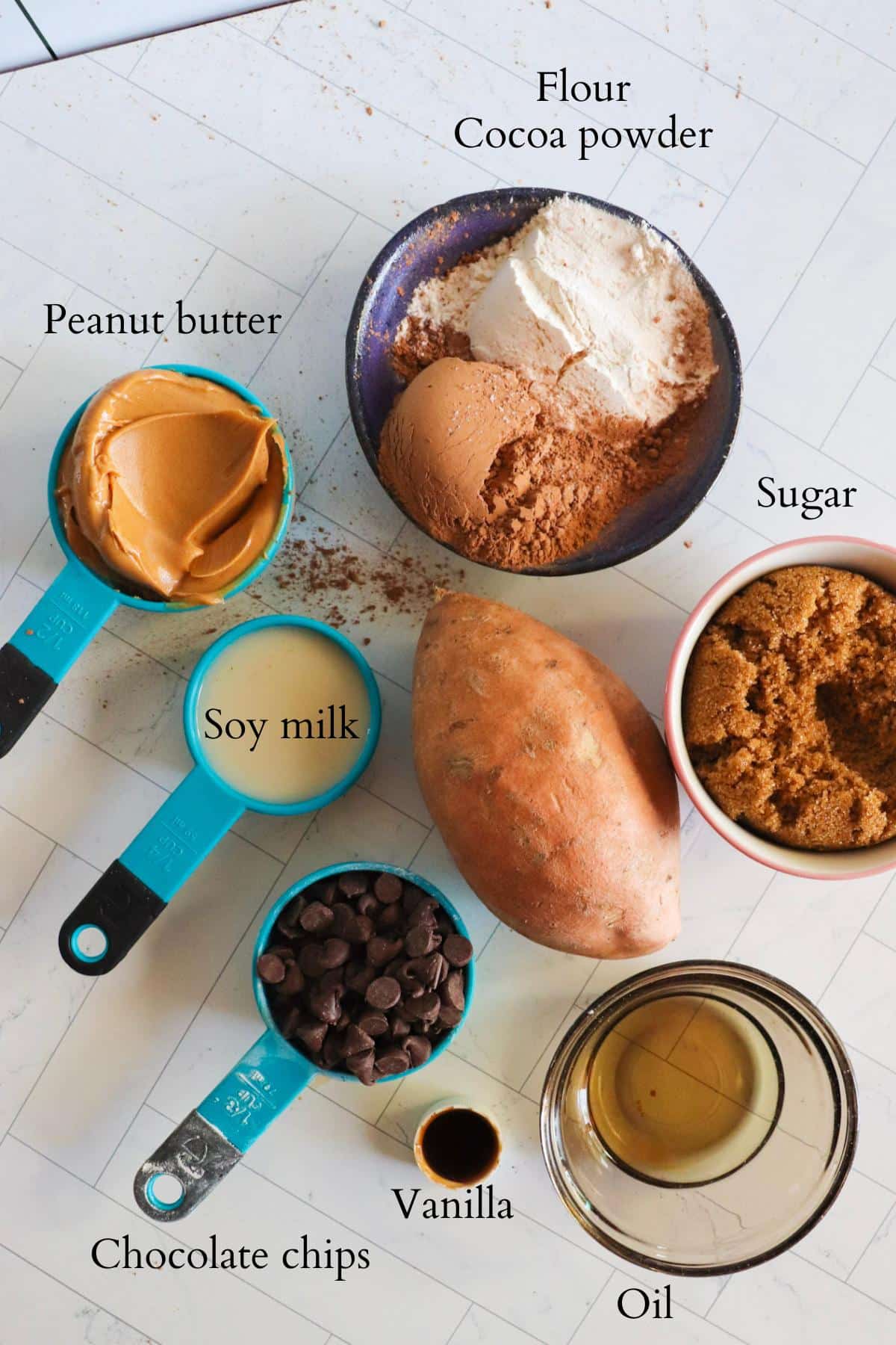 Ingredients for sweet potato brownies all laid out in their separate bowls on a counter top.