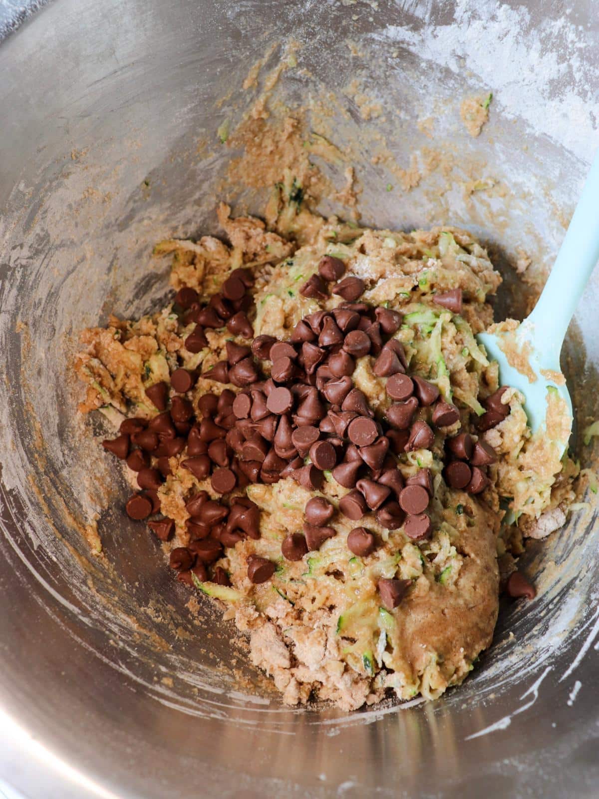 Batter for egg free zucchini muffins in a mixing bowl.