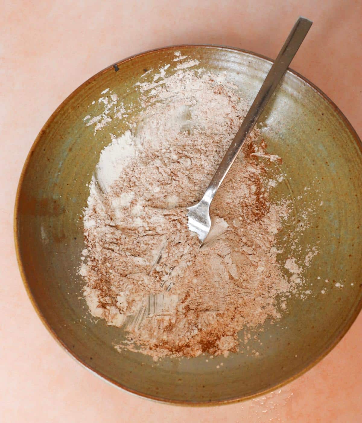 Dry ingredients for eggless french toast ingredients in a bowl with a fork.