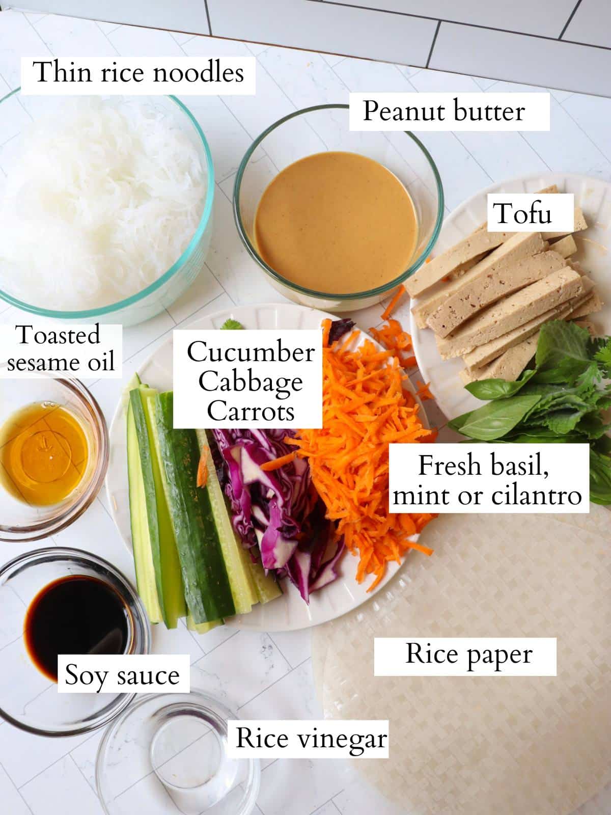 Ingredients for vegan summer rolls laid out on a kitchen counter.