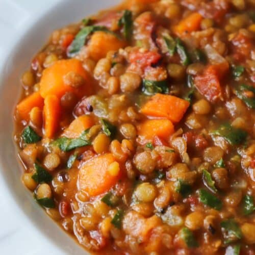 Sweet potato and lentil soup in a white bowl.