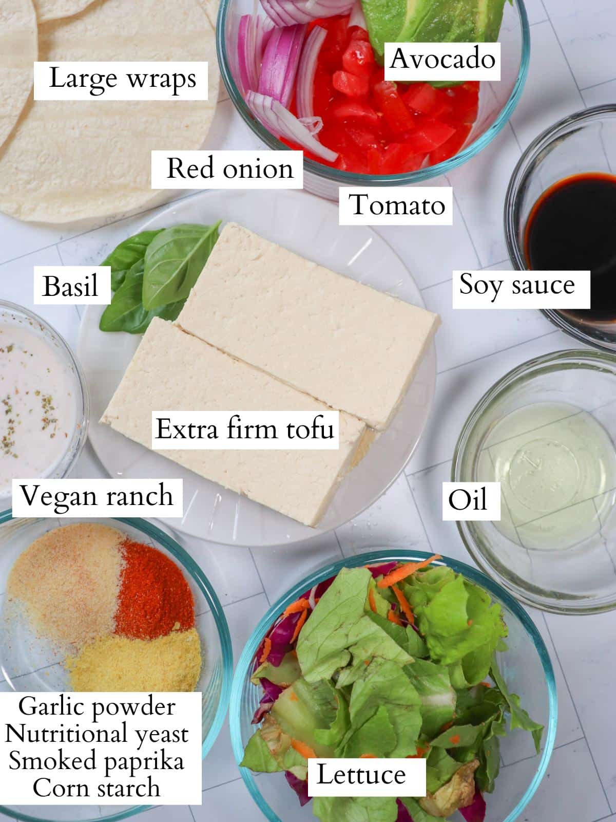 Ingredients for vegan tofu wrap laid out on a kitchen counter.
